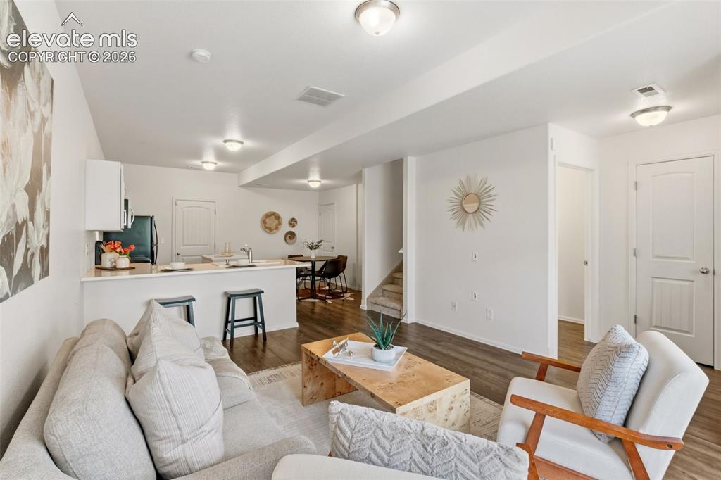 Image 7 of 38: The seamless flow between the living room and kitchen makes entertaining fa