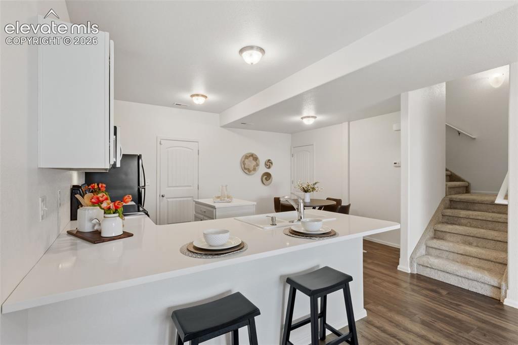 Image 9 of 38: A large center breakfast bar island anchors the kitchen, providing an ideal