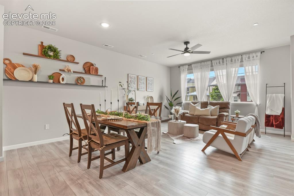 Image 10 of 29: Open-concept living area featuring light wood-finish flooring, recessed lig
