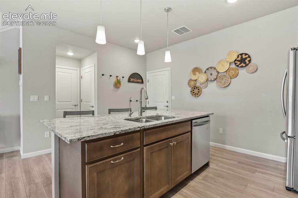 Image 13 of 29: Kitchen island featuring a double basin sink with a gooseneck faucet
