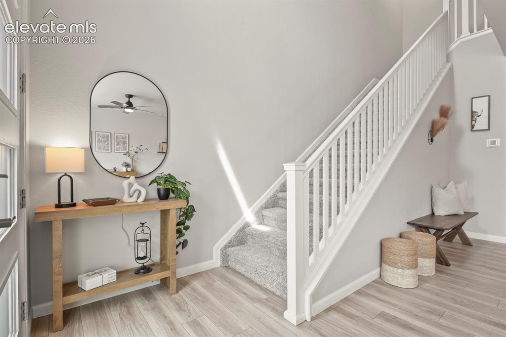 Image 4 of 29: Light wood-finish flooring complements the neutral wall tones