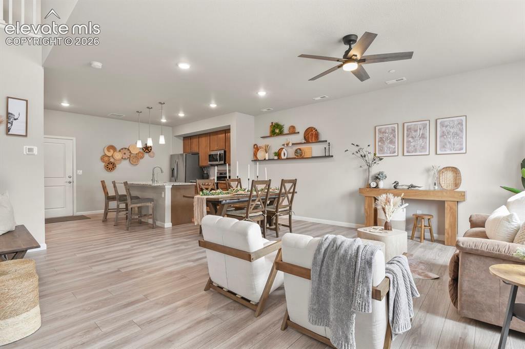 Image 5 of 29: Open-concept main living area with wood-finish flooring throughout