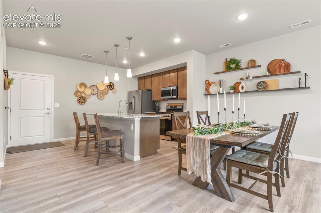 Image 8 of 29: Open-concept living space featuring wood-finish flooring