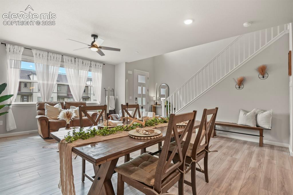 Image 9 of 29: Open-concept living space with wood-finish flooring extending throughout