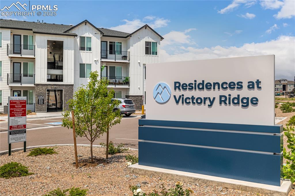 Image 2 of 10: Community / neighborhood sign featuring a residential view