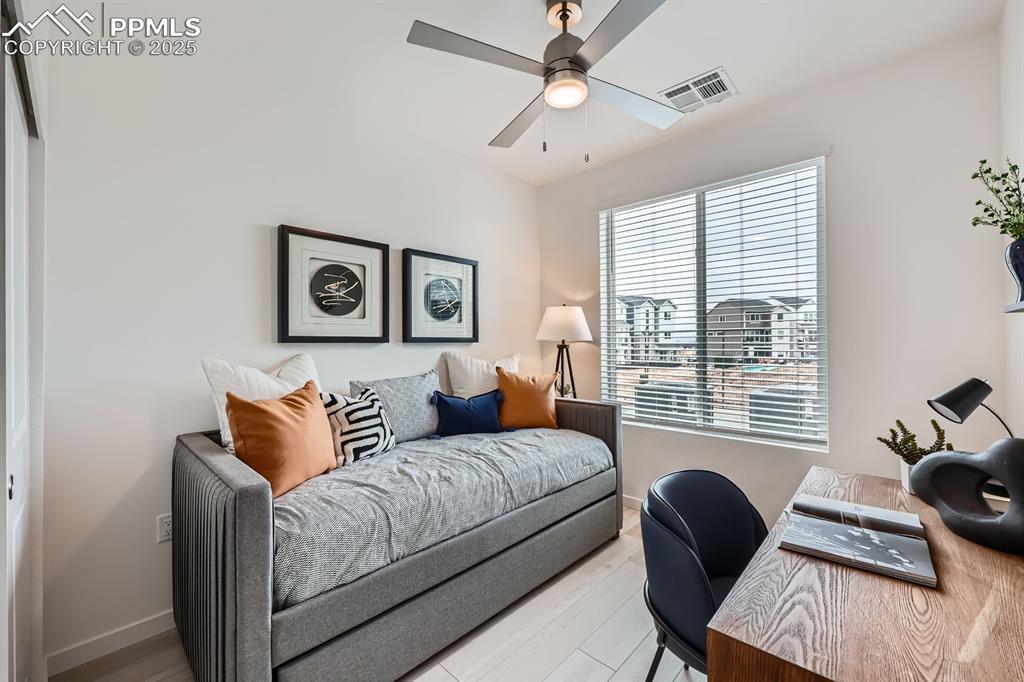Image 8 of 10: Office area featuring wood finished floors and a ceiling fan