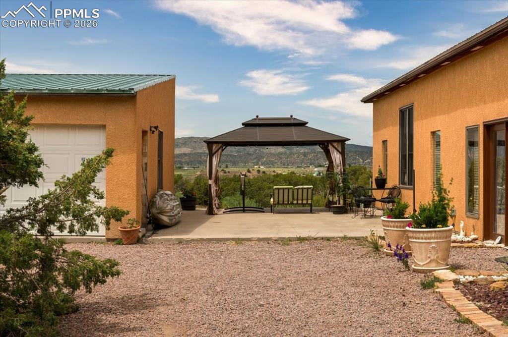 Image 31 of 33: Detached garage and pergola with views