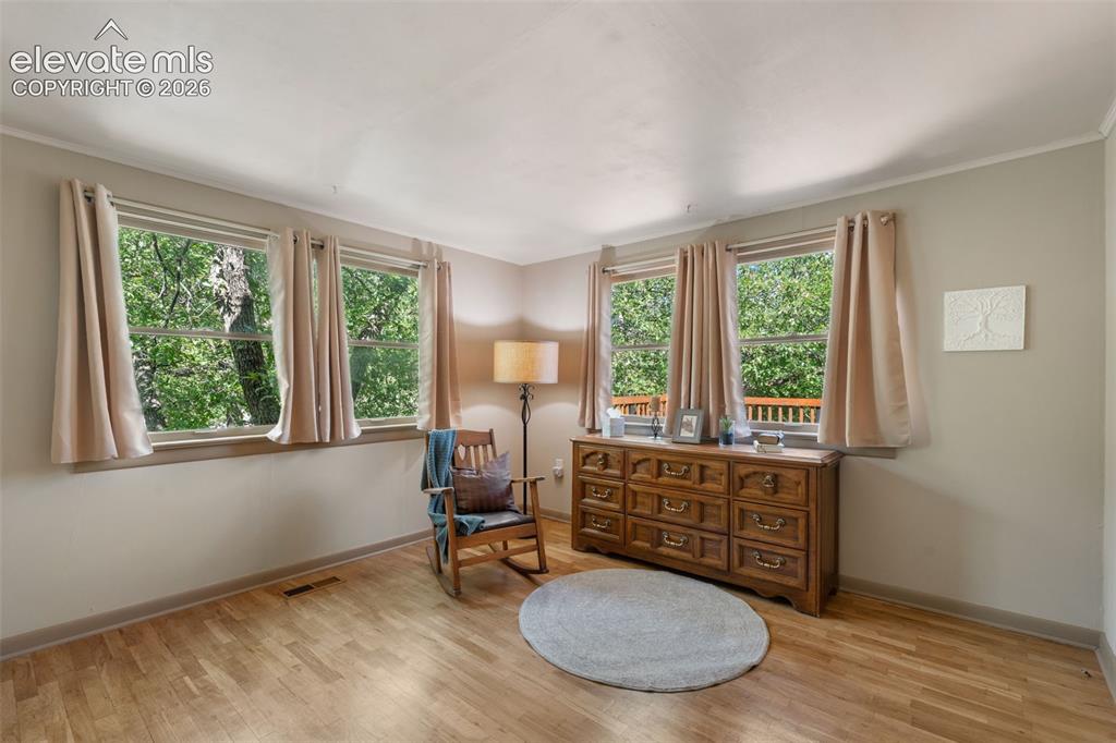 Image 23 of 40: Hardwood-finish flooring extending throughout the room