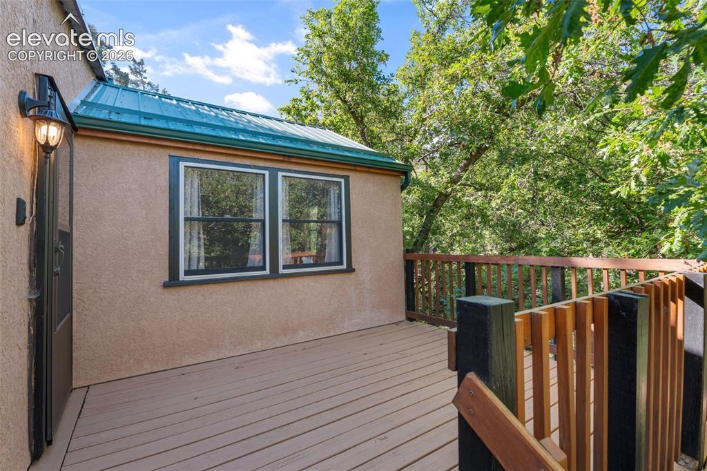 Image 5 of 40: Exterior deck with wood-finish flooring, featuring a wood railing system