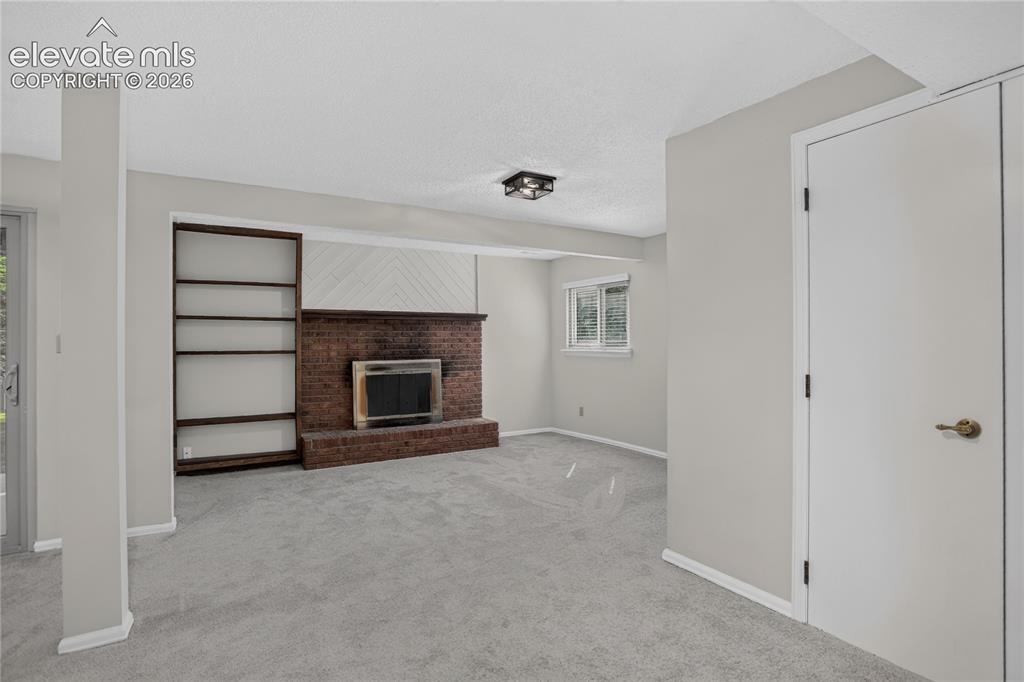 Image 18 of 30: Family room w/ fireplace - lower level