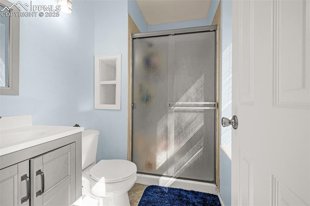 Image 17 of 30: Full bath with vanity, a shower stall, and tile patterned flooring