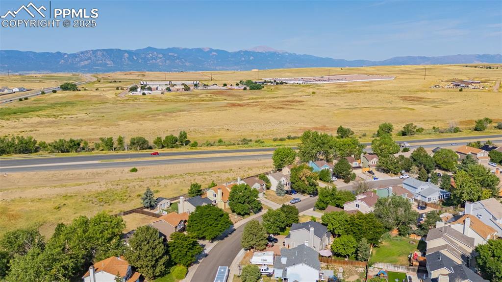 Image 27 of 30: Aerial view of sparsely populated area featuring nearby suburban area