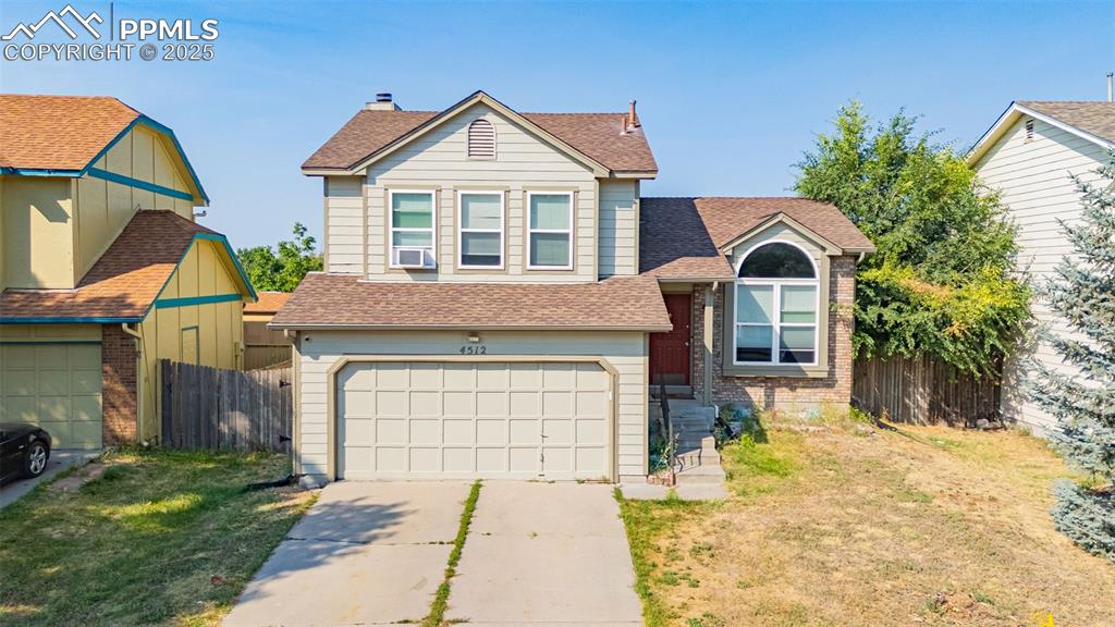 Image 30 of 30: View of front facade featuring roof with shingles, a garage, and concrete d