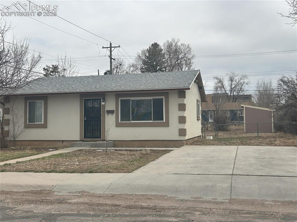 Image 13 of 16: View of front of house featuring roof with shingles and stucco siding