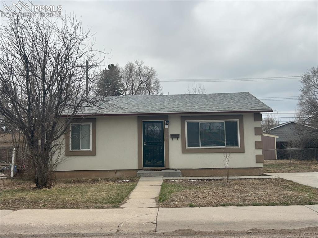 Image 4 of 16: Bungalow-style house with stucco siding and roof with shingles