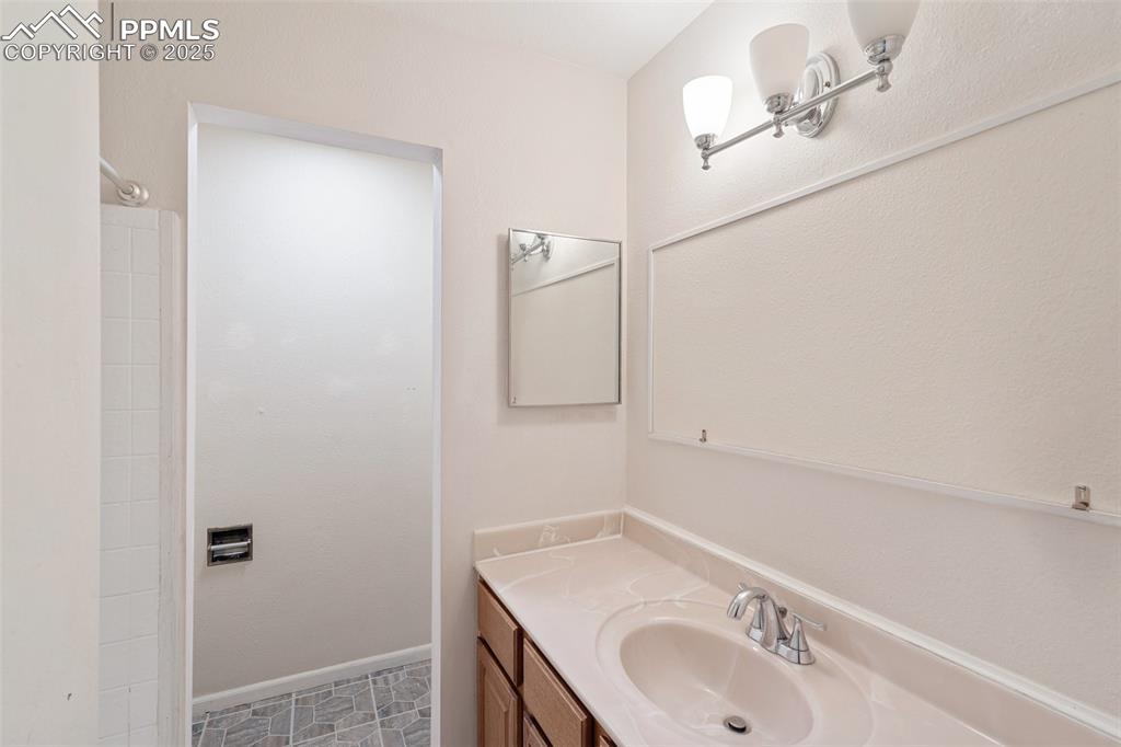 Image 16 of 25: Full Bathroom featuring vanity and a tub