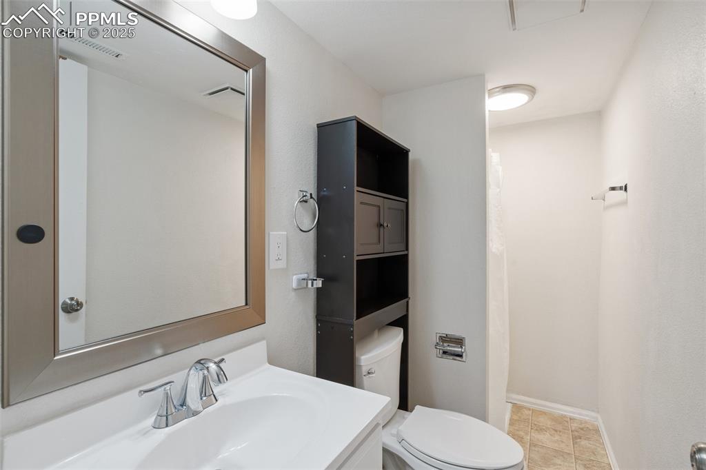 Image 20 of 25: Bathroom featuring vanity and light tile patterned floors