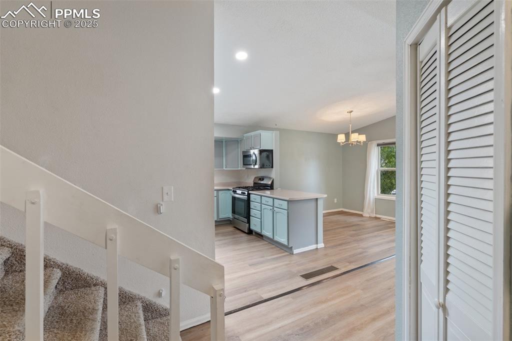 Image 5 of 25: Entry way with stairway featuring wood finished floors and a textured ceili