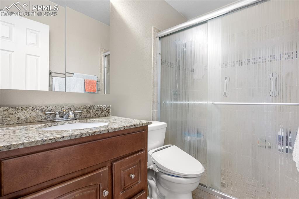 Image 13 of 38: Full bath with vanity and a stall shower