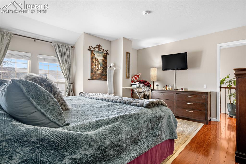 Image 15 of 38: Bedroom with light wood-style floors