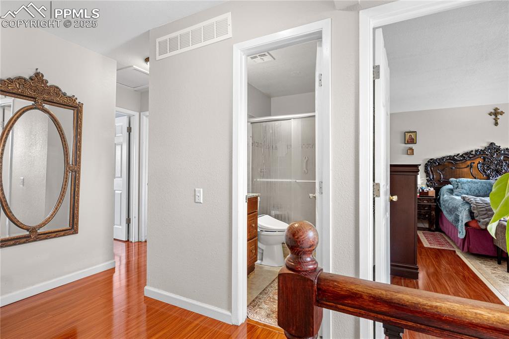 Image 18 of 38: Hallway with light wood finished floors and baseboards