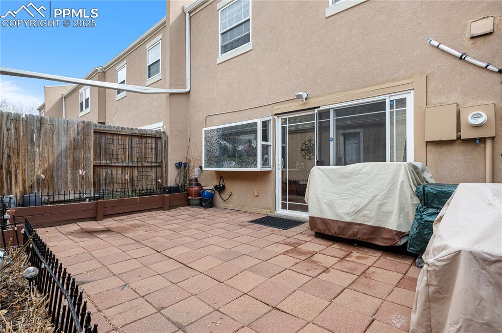 Image 21 of 38: Rear view of property featuring a patio area and stucco siding