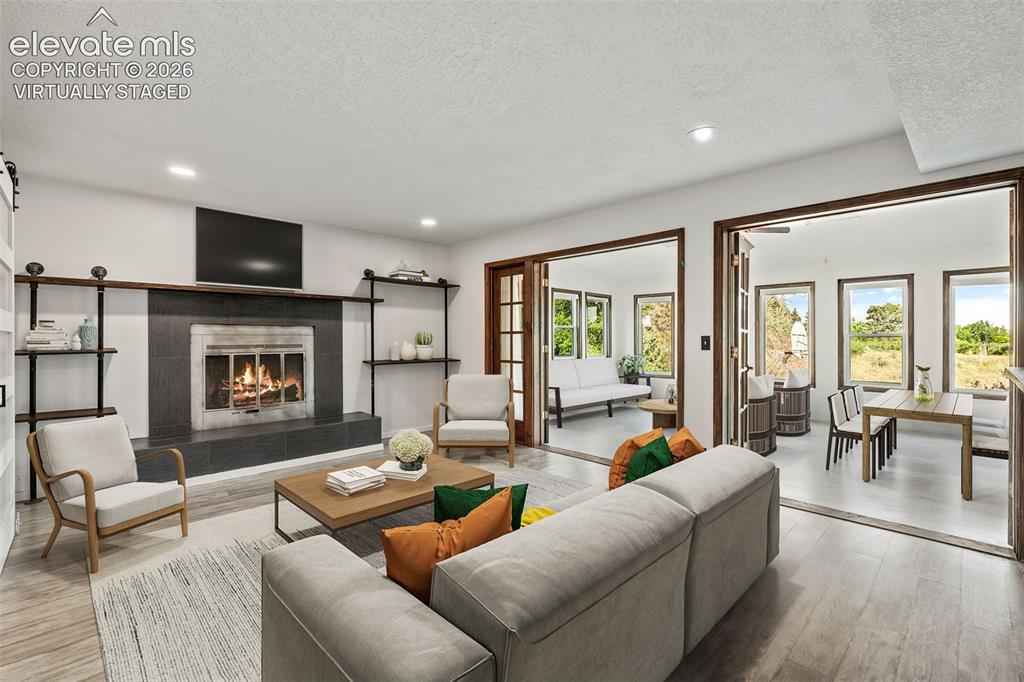 Image 11 of 50: Virtually staged Family Room with Fireplace