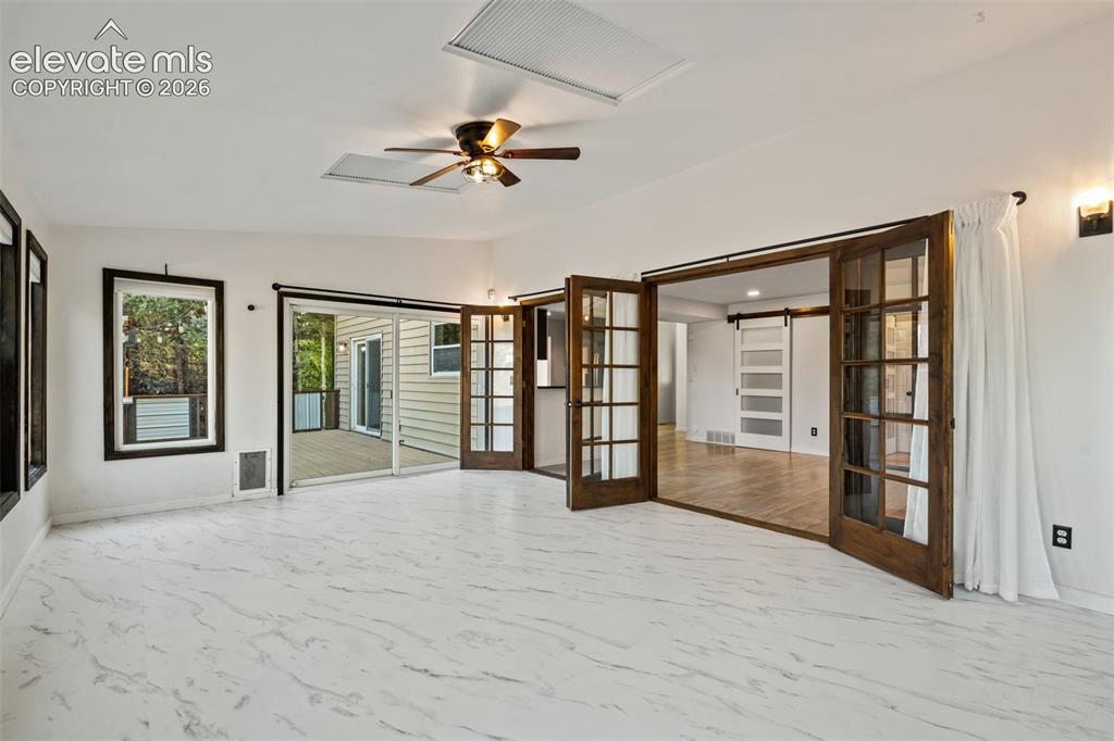Image 16 of 50: Sunroom with Walk Out to Deck