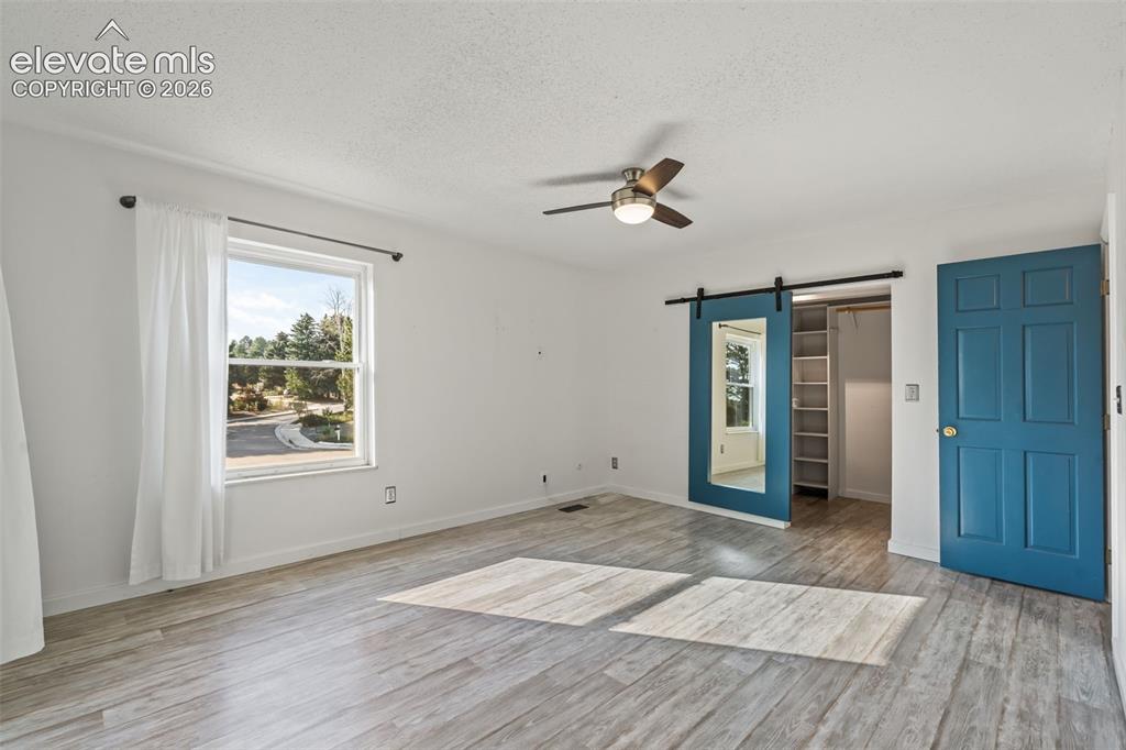 Image 18 of 50: Primary Bedroom with Adjoining Bath, Walk-In Closet and Balcony