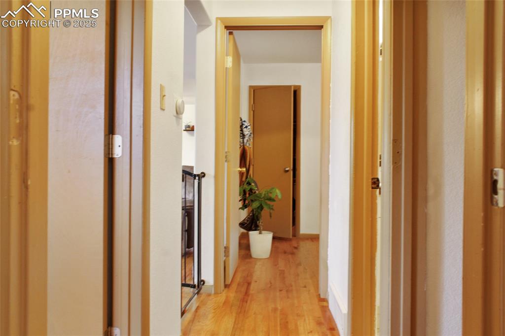 Image 10 of 28: Hallway featuring light wood-style flooring and baseboards