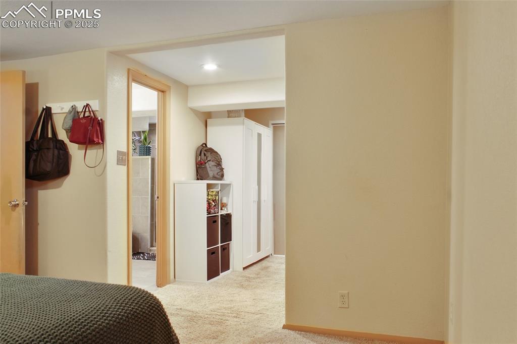 Image 14 of 28: Bedroom featuring light carpet and baseboards