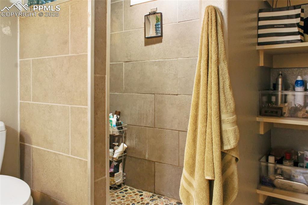 Image 16 of 28: Full bath featuring a stall shower and toilet