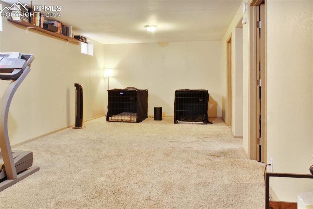 Image 18 of 28: Unfurnished room with carpet
