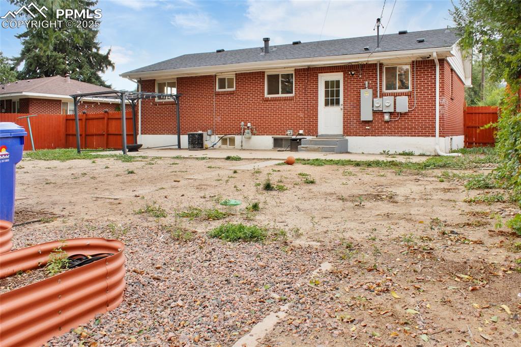 Image 22 of 28: Rear view of property featuring a patio and brick siding