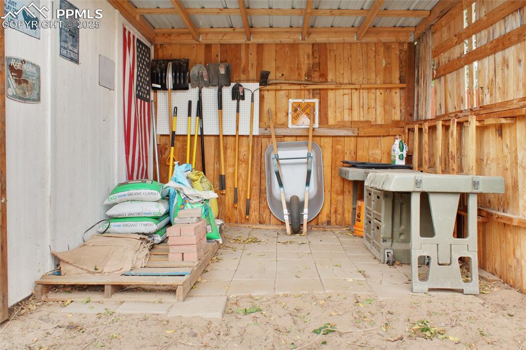 Image 26 of 28: Miscellaneous room with wood walls
