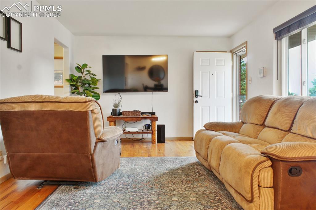 Image 5 of 28: Living room featuring wood finished floors and baseboards