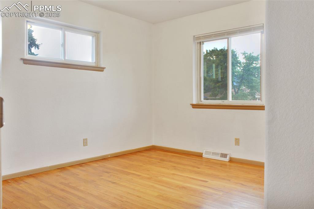 Image 9 of 28: Empty room with light wood-style flooring