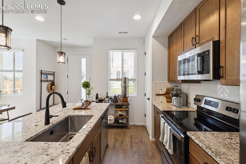 Image 13 of 46: Kitchen featuring stainless steel appliances, maple cabinets, an oversized 