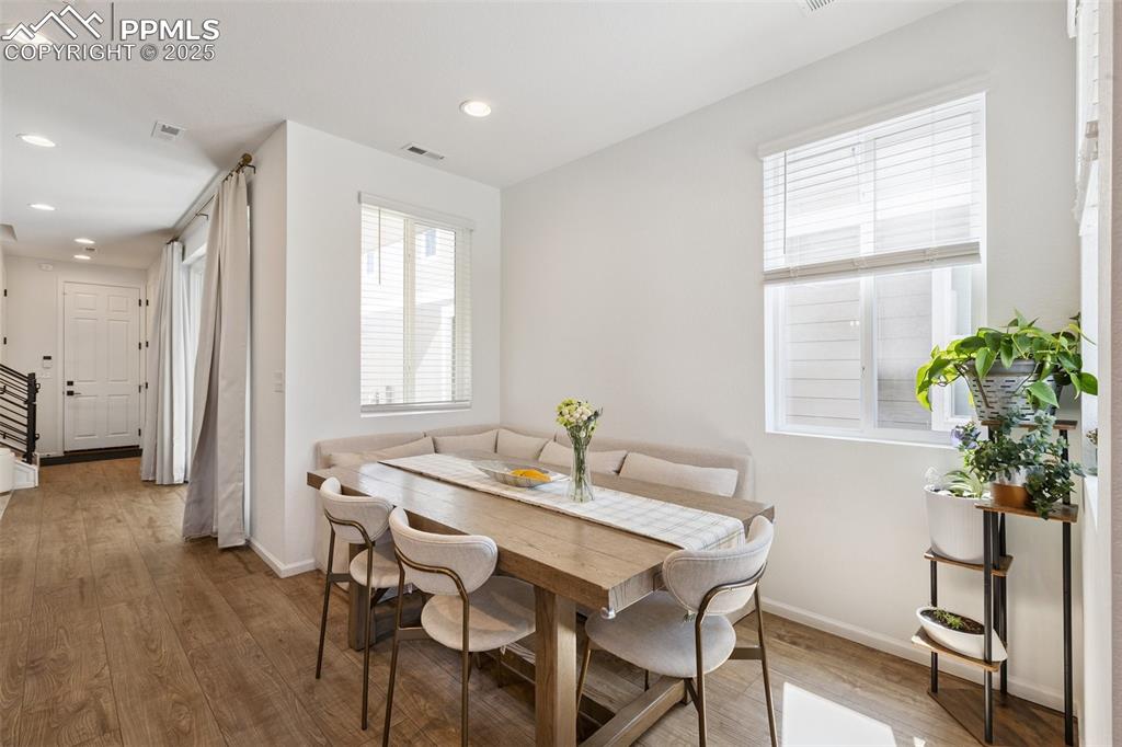 Image 17 of 46: Dining area with Luxury Vinyl Tile and recessed lighting