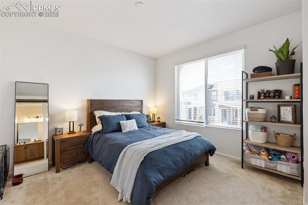 Image 21 of 46: Bedroom with light colored carpet