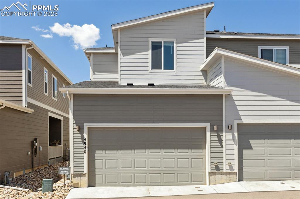 Image 35 of 46: View of back of home featuring an attached 2 car garage