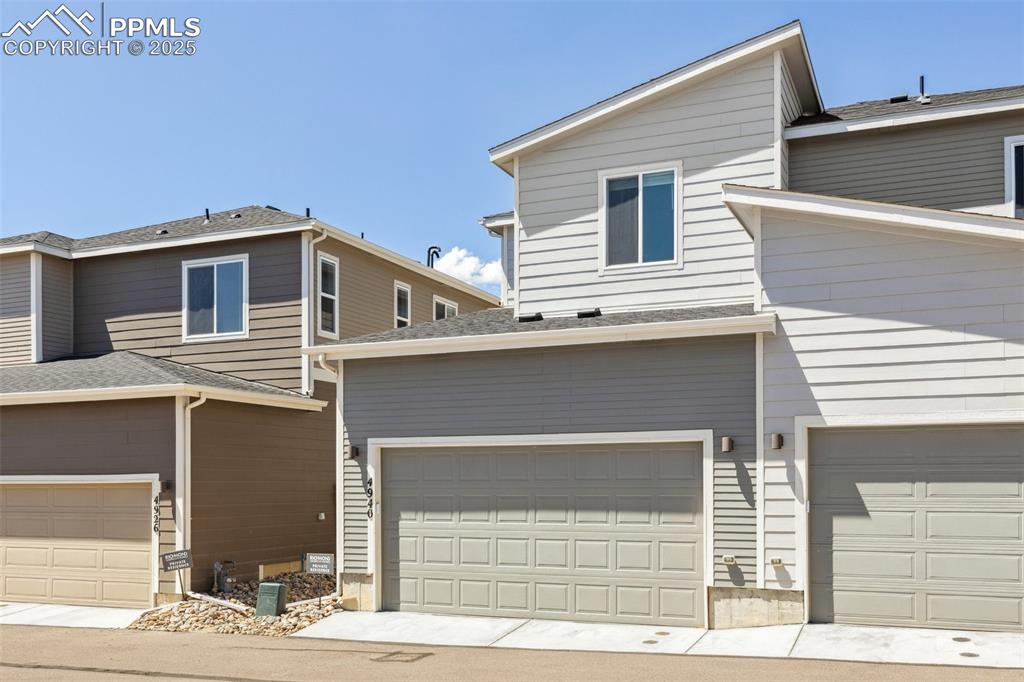 Image 36 of 46: View of back of home featuring an attached 2 car garage