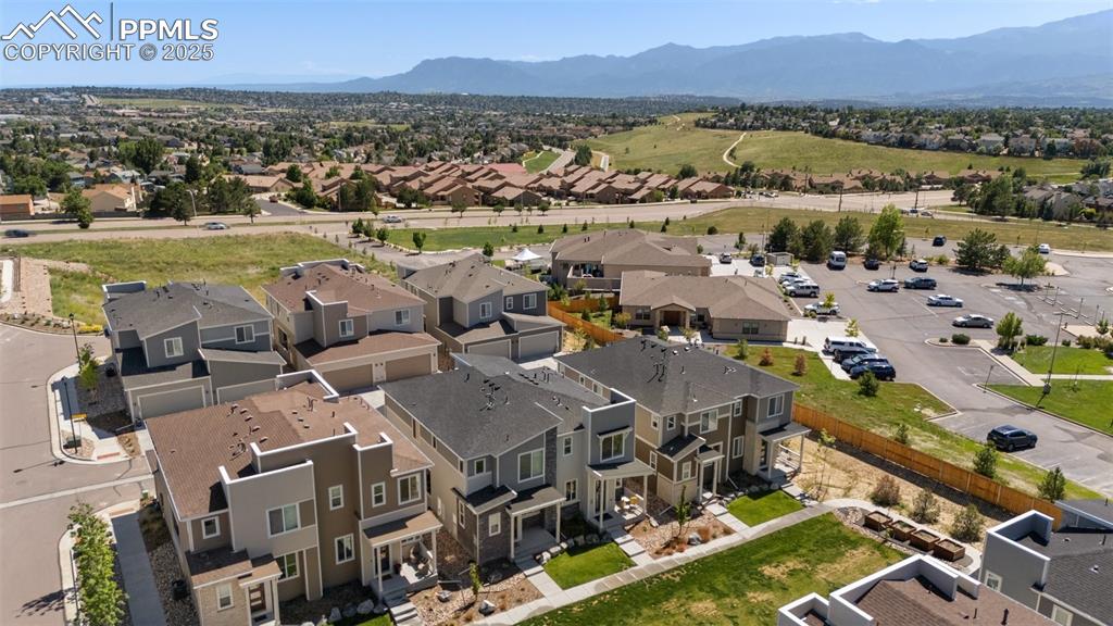 Image 39 of 46: Front aerial perspective of suburban area featuring mountains