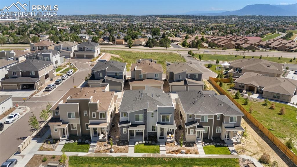 Image 40 of 46: Front aerial view of residential area featuring mountains