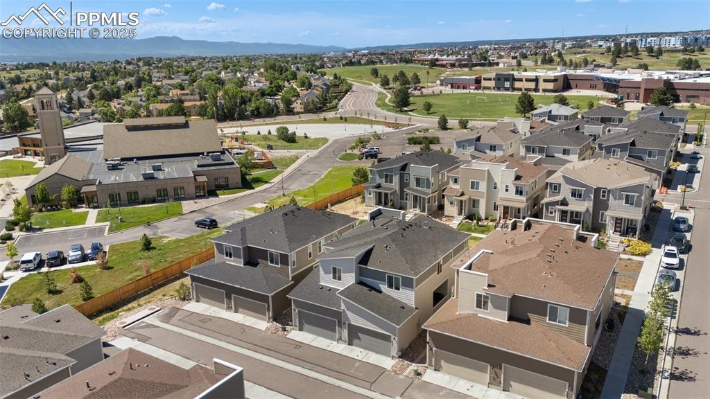 Image 41 of 46: Back of structure aerial perspective of suburban area featuring a mountaino
