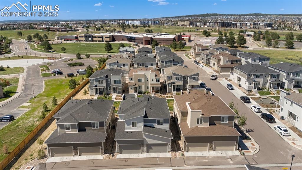 Image 42 of 46: Back of structure aerial view featuring nearby suburban area