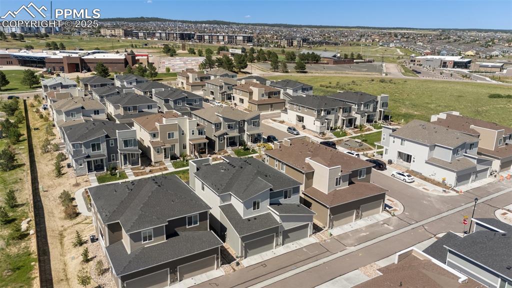 Image 43 of 46: Back of struture aerial overview featuring nearby suburban area
