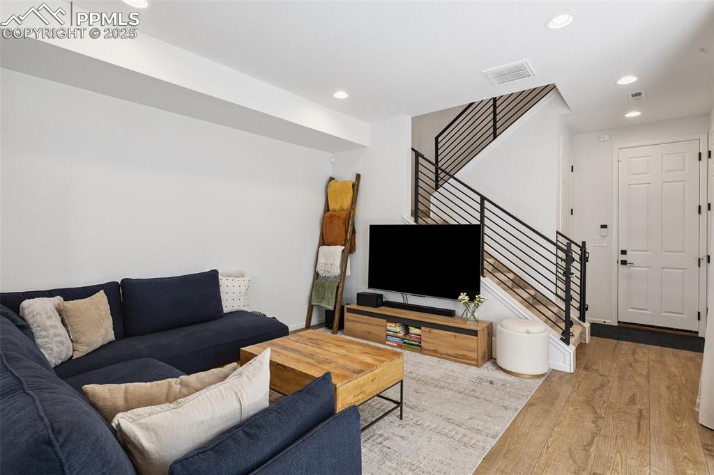 Image 7 of 46: Living area with stairs, access to covered patio, Luxury Vinyl Tile floorin