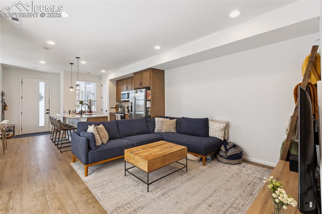 Image 9 of 46: View of open floor plan, the living area with stairs, access to covered pat