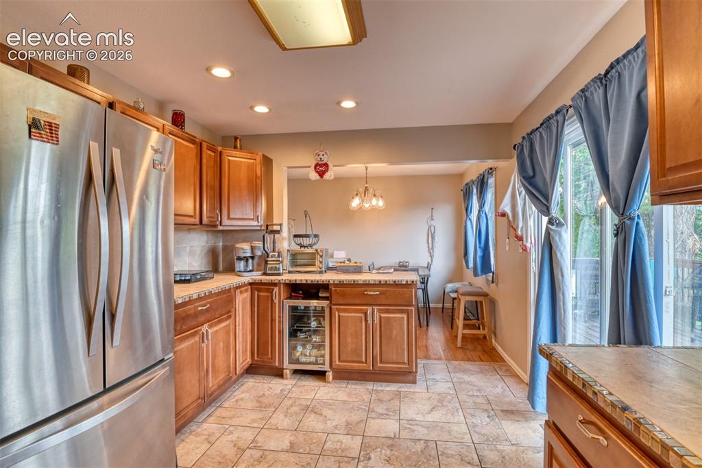 Image 11 of 46: Kitchen featuring stainless steel appliances, wood cabinetry, recessed ligh